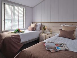 A bedroom with two beds and a window at Epic Spa in Laugharne