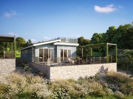 A building with a terrace and garden at Epic Spa (Pet) Laugharne