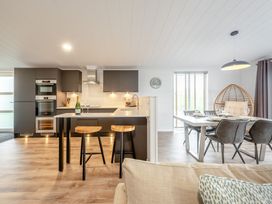 A kitchen with a stove and sink at Sonnet 3 Spa (Pet) Laugharne