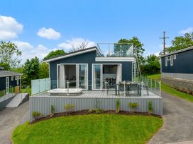 A house with a deck and hot tub at Sonnet 3 Roof Terrace Spa Laugharne
