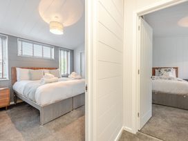 A bedroom with two beds and a bedside table at Sonnet 3 Roof Terrace Spa in Laugharne