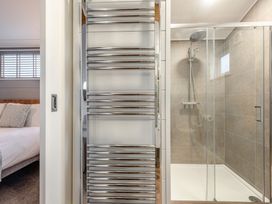 A bathroom featuring a shower and towel rail at Sonnet 3 Roof Terrace Spa in Laugharne