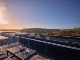 A terrace with a table and a view at Epic Spa (Roof Terrace) in Laugharne
