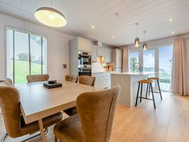 A kitchen with a dining table and chairs at Epic Spa (Roof Terrace) Laugharne