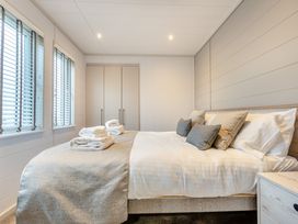 A bedroom with a bed and wardrobe at Epic Spa (Roof Terrace) Laugharne