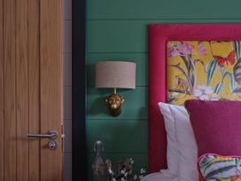 A bedroom with a bed and decorative elements at Wilde in Laugharne