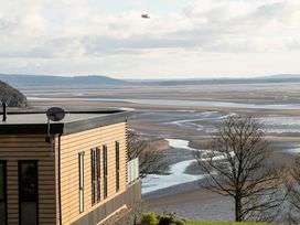 An exterior view of a building overlooking a coastal landscape at Solace in Laugharne