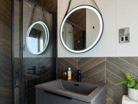 A bathroom with a mirror and sink at Solace in Laugharne