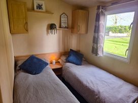 A bedroom with two single beds at Caravan 1 at Blackmoor Farm near Tenby