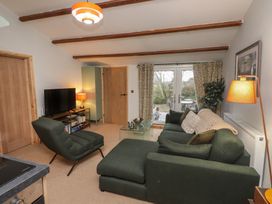 A living room with a sofa and television at 20 Chatham Log Cabins in Caernarfon