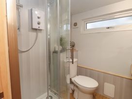 A bathroom with a shower and a toilet at 20 Chatham Log Cabins Caernarfon