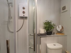 A bathroom with a shower and toilet at 20 Chatham Log Cabins Caernarfon