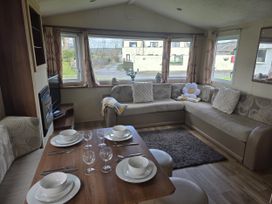A living room with a dining table and sofa at Caravan 5 at Blackmoor Farm near Tenby
