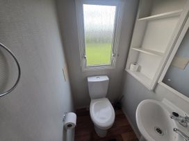 A bathroom with a toilet and sink at Caravan 5 at Blackmoor Farm near Tenby Narberth