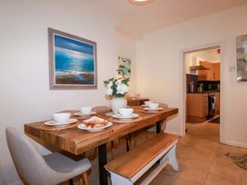 A dining room with a wooden table and chairs at Chapel Cottage in Mevagissey