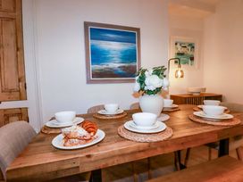 A dining room with a table set for breakfast at Chapel Cottage in Mevagissey