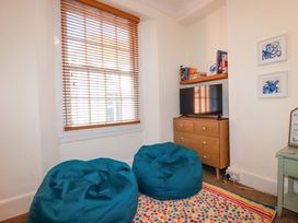 A living room with bean bags and a television at Chapel Cottage in Mevagissey