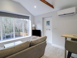 A living room with a sofa, table and television at Lodge at Nadur