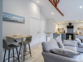 A living room with a sofa and bar table at Lodge at Nadur