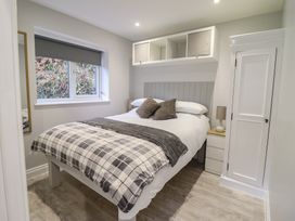 A bedroom with a bed and mirror at Lodge at Nadur