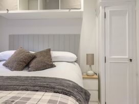 A bedroom with a bed and bedside lamp at Lodge at Nadur