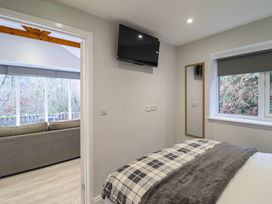 A bedroom with a bed and television at Lodge at Nadur