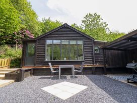 An outdoor area with a table and chairs at Lodge at Nadur Commins Coch near Machynlleth