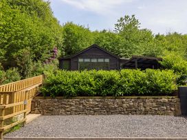 A cabin surrounded by trees and plants at Lodge at Nadur Commins Coch near Machynlleth
