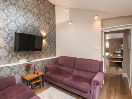 A living room with a sofa and television at Sunnyvale House in Whitby