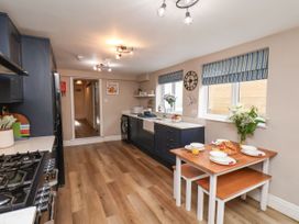 A kitchen with a table and chairs at Sunnyvale House in Whitby