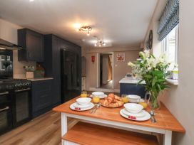 A kitchen with a dining table set for breakfast at Sunnyvale House in Whitby