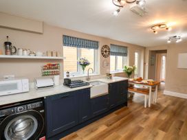 A kitchen with a sink and dining table at Sunnyvale House in Whitby