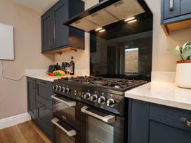 A kitchen with cabinets and a stove at Sunnyvale House in Whitby