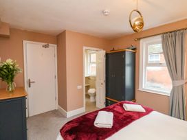 A bedroom with a bed and wardrobe at Sunnyvale House in Whitby
