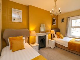 A bedroom with two beds and a fireplace at Sunnyvale House in Whitby