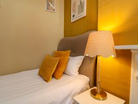 A bedroom with a bed and lamp at Sunnyvale House in Whitby