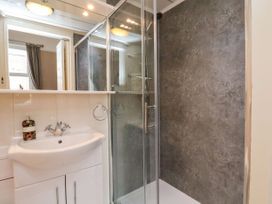 A bathroom with a shower and washbasin at Sunnyvale House in Whitby