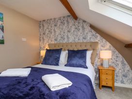 A bedroom with a bed and bedside table at Sunnyvale House in Whitby