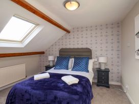 A bedroom with a bed against a decorated wall at Sunnyvale House in Whitby