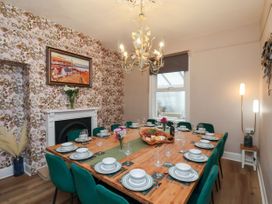 A dining room with a large table set for meals at Sunnyvale House in Whitby