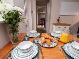 A dining table with plates and croissants at Sunnyvale House in Whitby