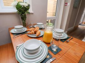A dining table set with plates, bowls and croissants at Sunnyvale House in Whitby