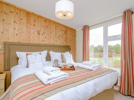 A bedroom with a bed and window at The Fotheringhay (Pet) in Kings Cliffe
