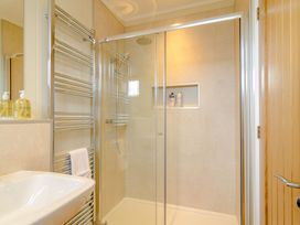 A bathroom with a shower and sink at The Fotheringhay (Pet) in Kings Cliffe