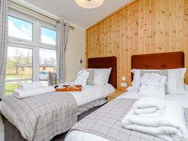 A bedroom with two beds and a tray with snacks at The Folkesworth (Pet) in Kings Cliffe