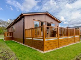A house with decking and fence at The Alwalton (Pet) Kings Cliffe