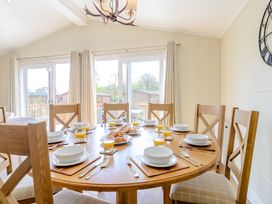 A dining room with a round table set for breakfast at The Alwalton (Pet) Kings Cliffe