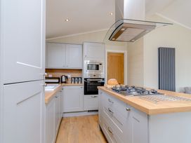 A kitchen with cabinets and appliances at The Alwalton (Pet) in Kings Cliffe