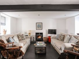 A living room with sofas and a fireplace at Bryn Tegid in Beaumaris