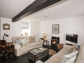A living room with sofas and a fireplace at Bryn Tegid in Beaumaris